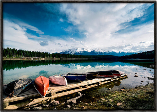 Landscape art: canoes on a wooden jetty – Black Frame