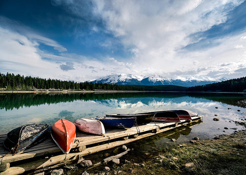 Landscape art: canoes on a wooden jetty