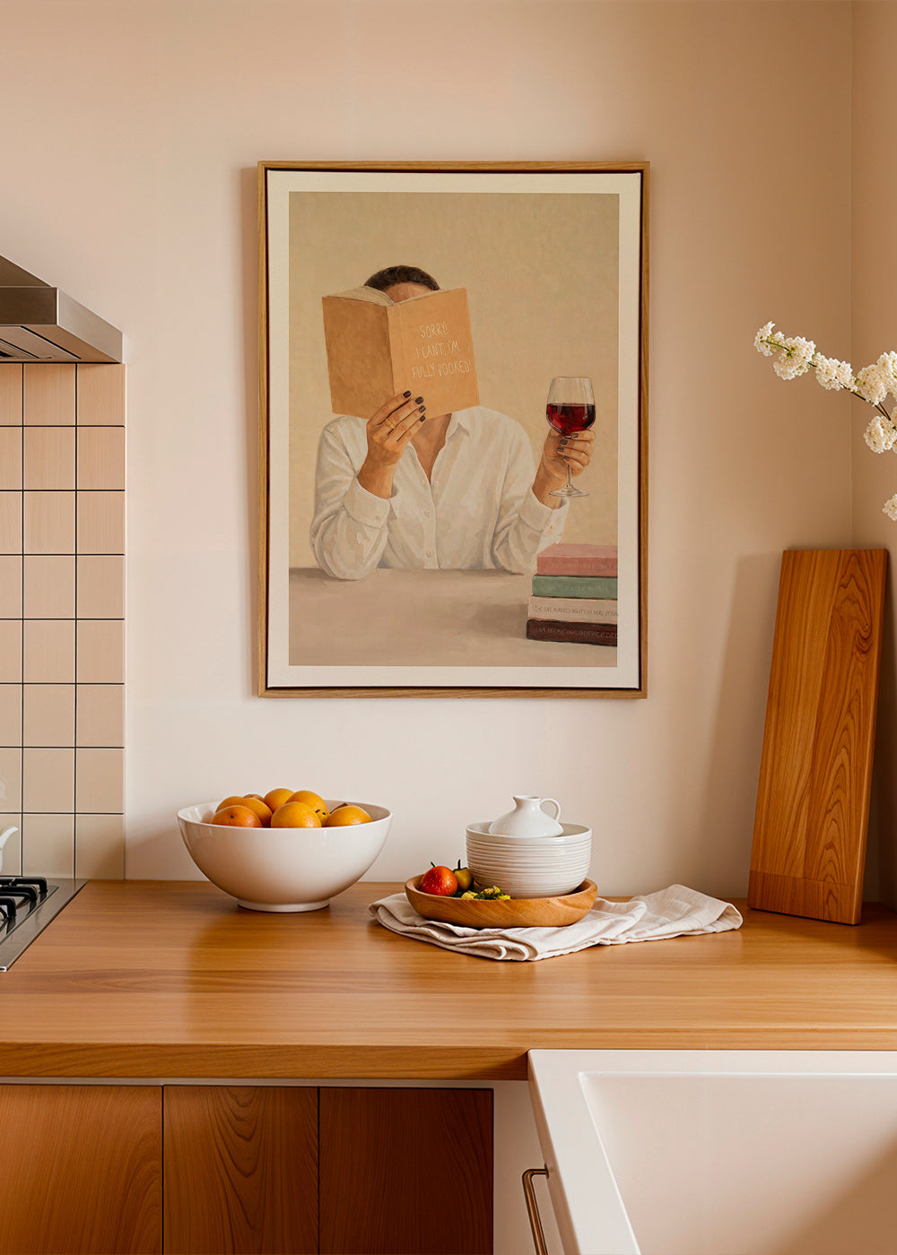 Kitchen art: woman reading with a glass of wine