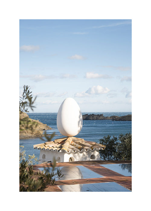 Landscape art with sculptural egg by the sea