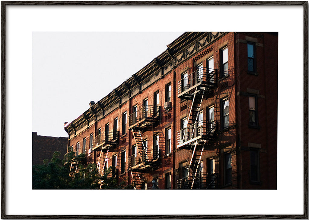 Travel poster: New York brownstone facade with fire escapes