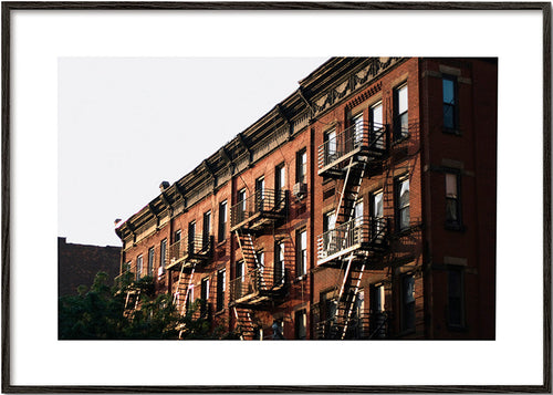 Travel poster: New York brownstone facade with fire escapes