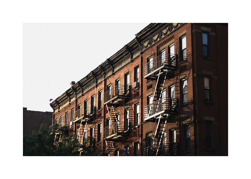 Travel poster: New York brownstone facade with fire escapes