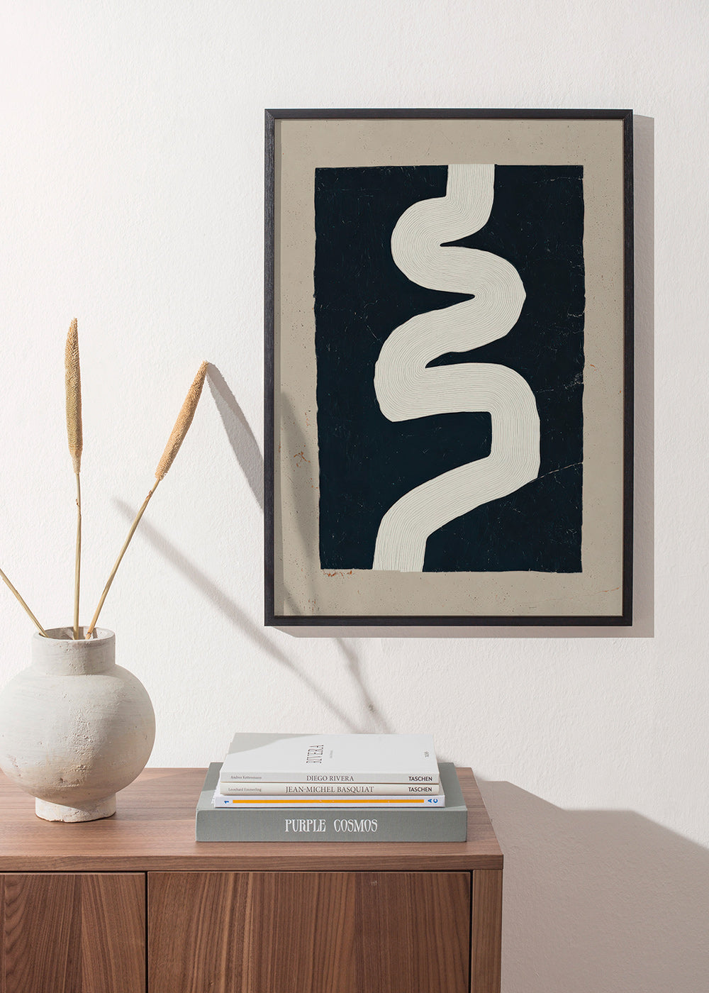 Minimalist print with a white curve on a dark panel