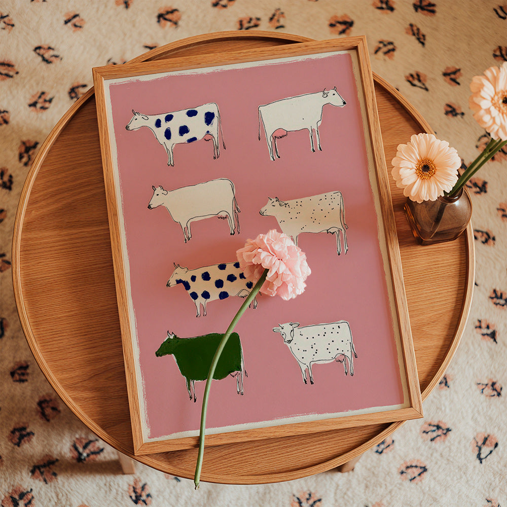 Artwork with playful cows on pink background