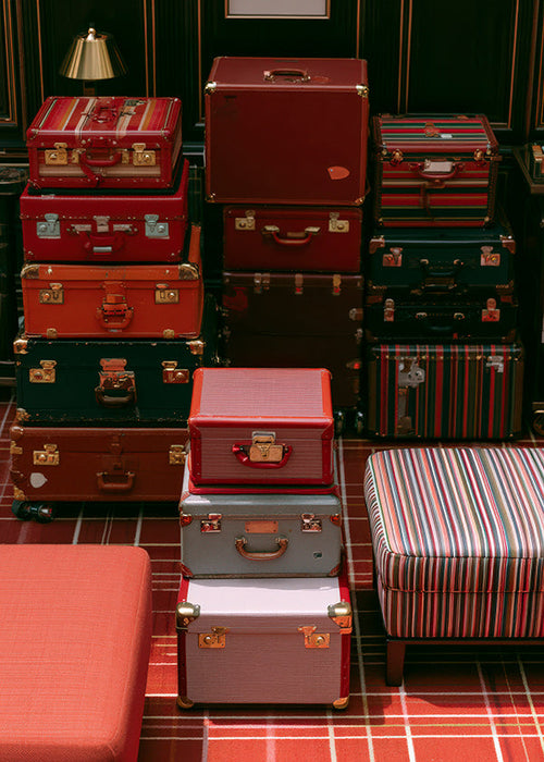 Travel art with stacked red luggage