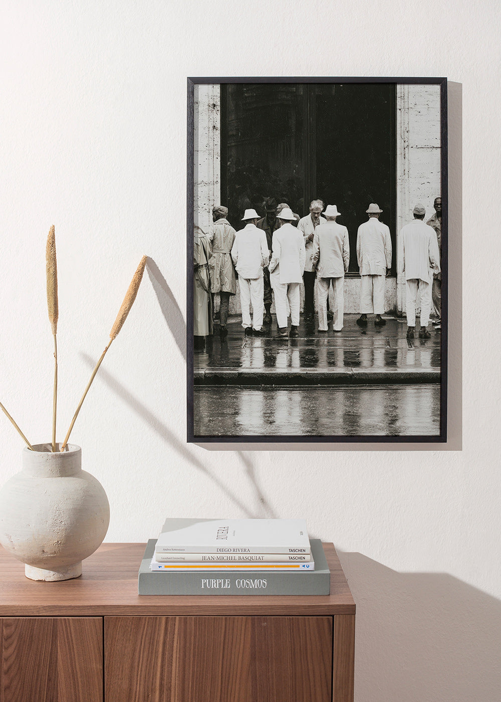 Black and white photo of men from the back in rain