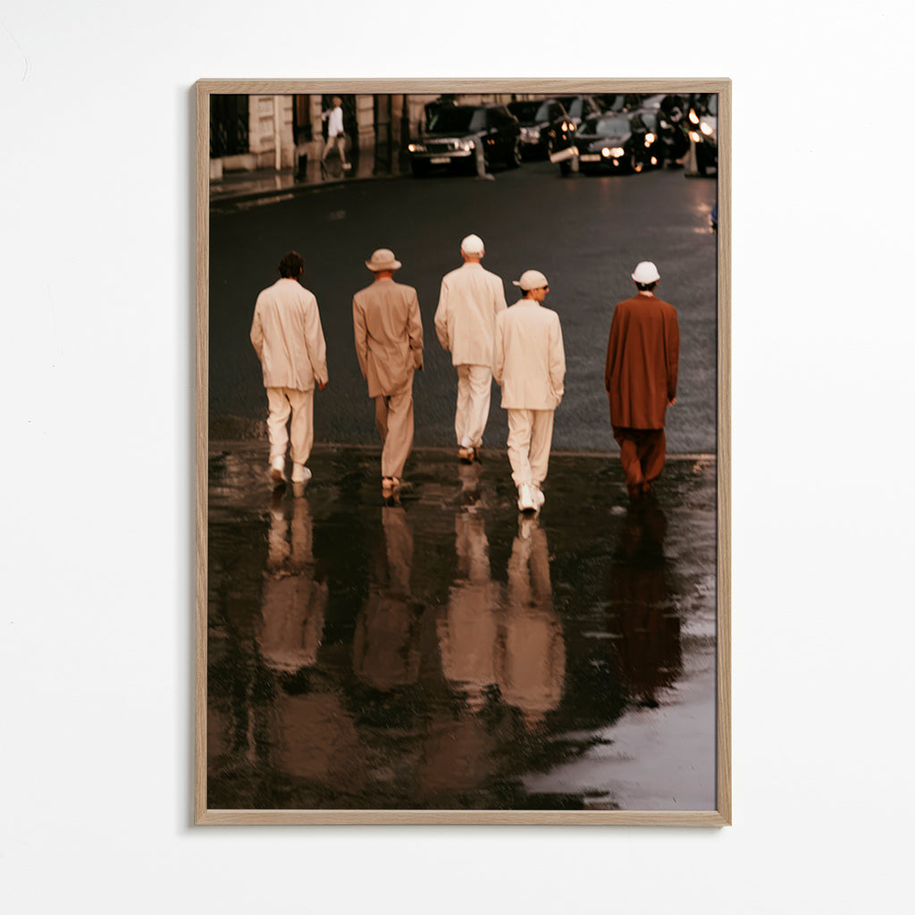 Photograph: five figures walking on a wet street