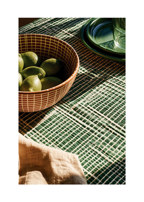 Kitchen art with limes in bowl and graphic cloth