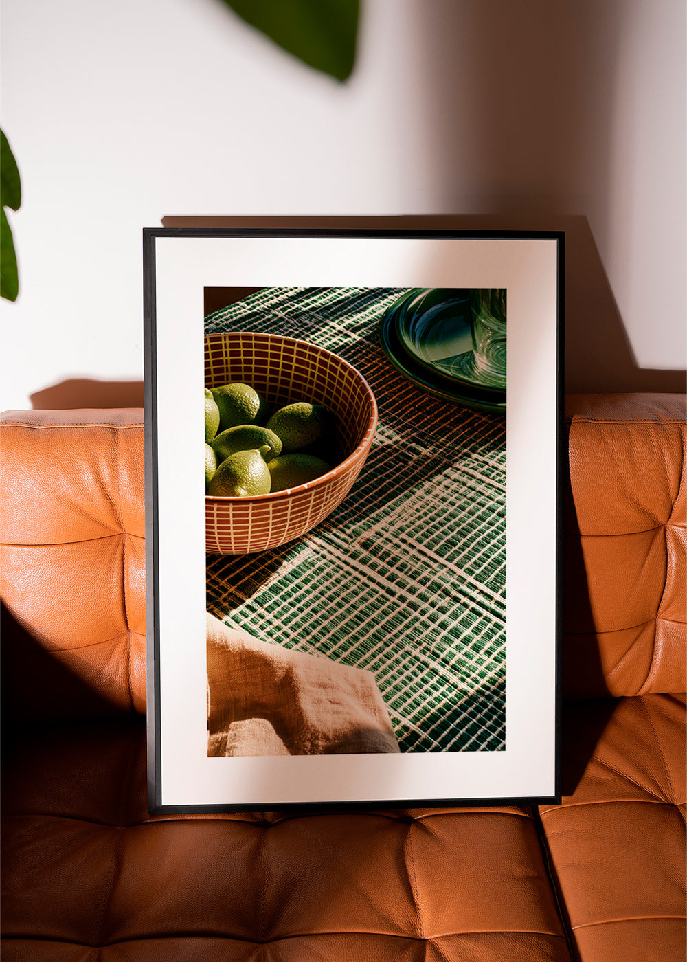 Kitchen art with limes in bowl and graphic cloth