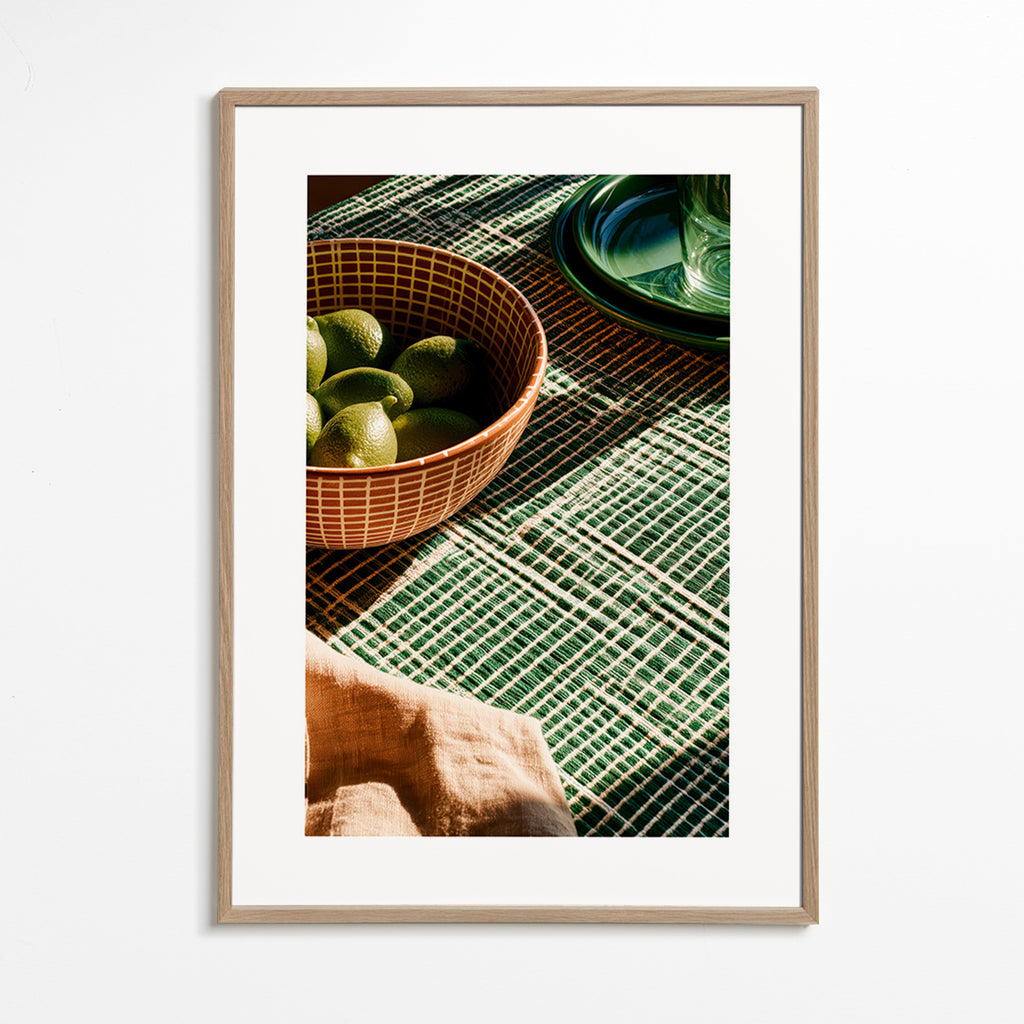 Kitchen art with limes in bowl and graphic cloth